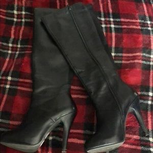 Knee high black high heeled boots